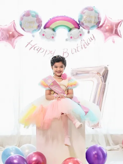 We celebrate milestones at every age. This vibrant 7th birthday photoshoot, complete with a custom rainbow theme and a happy birthday girl, shows how we tailor sessions for older kids too.