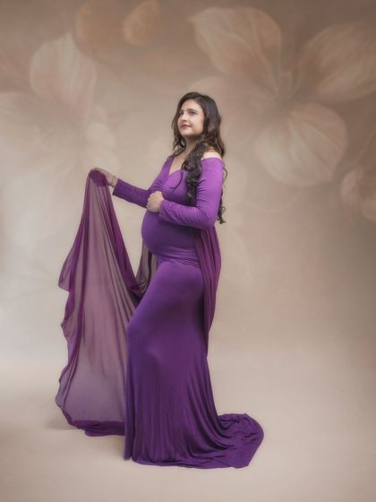 The elegance of motherhood captured in the soft flow of fabric. Draped in purple, this mama radiates quiet strength and grace in a truly magical shot.