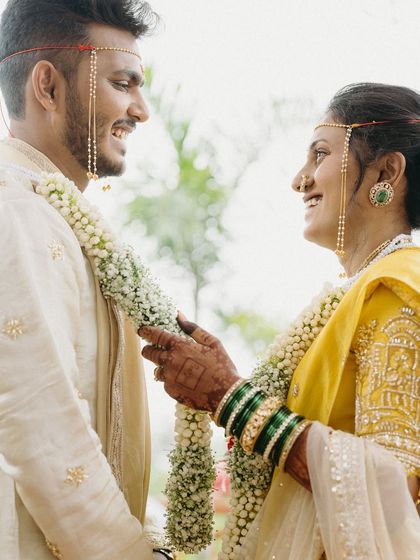 During their Maharashtrian wedding, Pratik and Yamini share a look of pure happiness. This candid portrait captures the essence of their eight-year journey, a friendship that blossomed into forever.