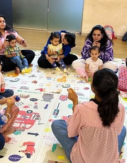 A candid shot of our class circle, where I guide the families through a song. The small group size of 12-15 families helps create an intimate and comfortable atmosphere.