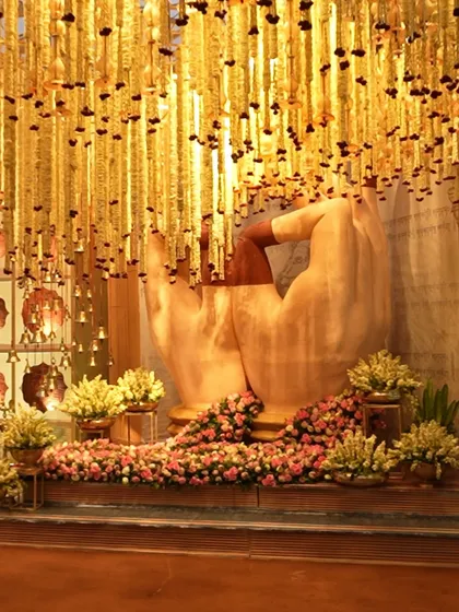 An opulent wedding setup featuring a stunning floral sculpture and cascading tuberose garlands. We work to create breathtaking backdrops that make your celebration truly unforgettable.