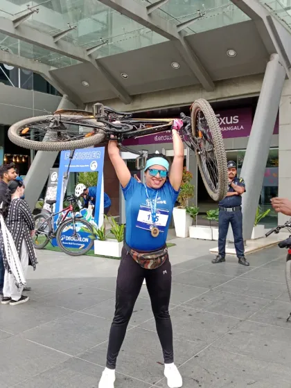 Celebrating World Bicycle Day after a cyclothon. I'm not just hosting; I'm a participant and a strong advocate for sustainable fitness, lifting my bike in triumph.