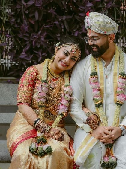 A sweet and relaxed portrait of the couple after their ceremony. The bride resting her head on the groom's shoulder shows their comfort and deep affection.