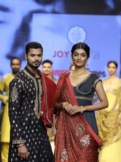 A final pose for the cameras at the Joy Mitra show, presenting a regal and cohesive look for the collection.