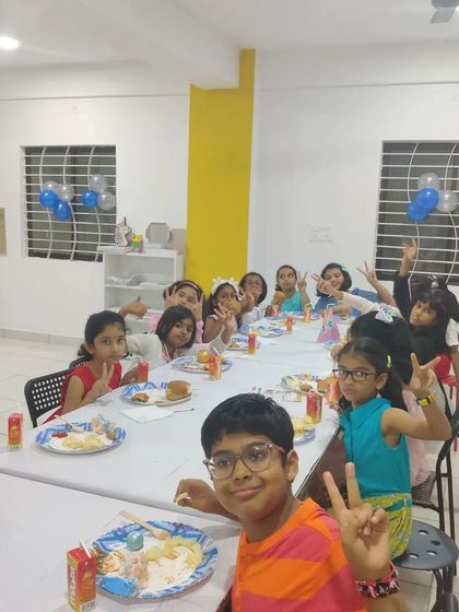 Making memories together at a fun-filled birthday art party. The kids are enjoying some snacks after finishing their awesome creations.