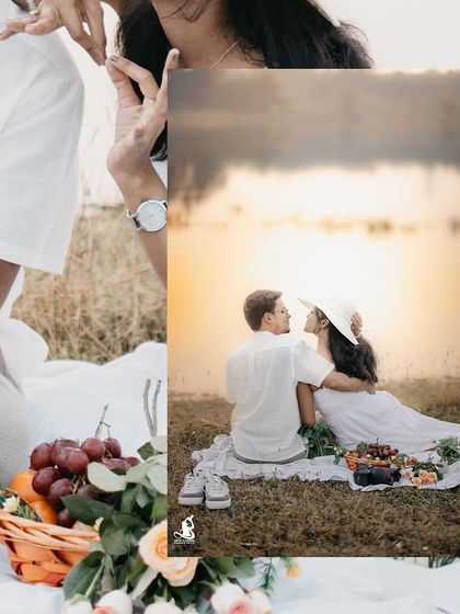 A beautifully framed shot of a couple enjoying their picnic, with a basket of fresh fruit adding a pop of color.
