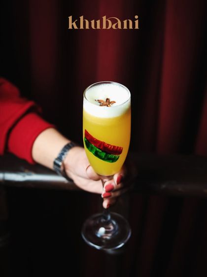 A velvet pour of citrus gold, topped with foam and crowned with a single star anise. This cocktail is bold, balanced, and effortlessly glamorous.