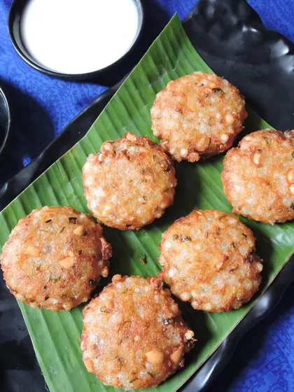 Our Sabudana Vada is a classic Maharashtrian delight. These crispy, savory fritters made from tapioca pearls are served with green chutney and yogurt, perfect for any time.