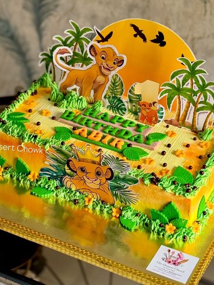 A full view of the vibrant Lion King themed sheet cake, showing all the jungle details and character toppers.