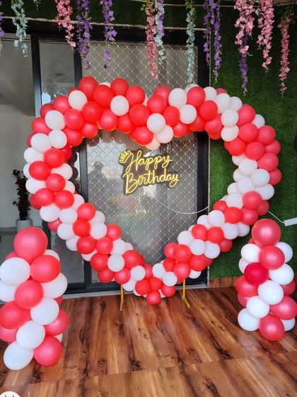 Here is another view of the red and white heart-shaped balloon arch. It is supported by a stand, making it easy to place anywhere in your home or party venue as a central decoration piece.