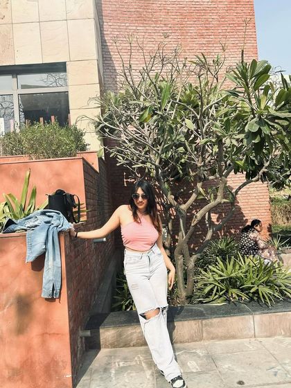 A sunny day look with a pink crop top and distressed jeans. This shows a more playful and summery side of my casual style.