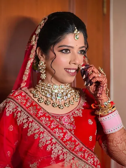A candid moment of the bride adjusting her nath, looking absolutely graceful.