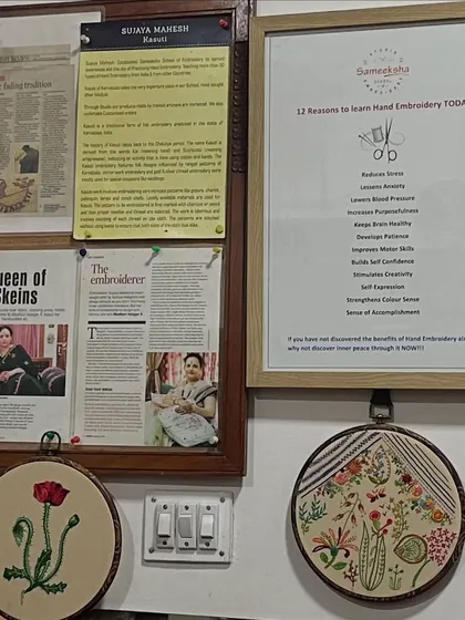 A view of my studio wall, where I display finished hoop art alongside newspaper articles about my work. It's a space filled with inspiration and the stories of my craft.