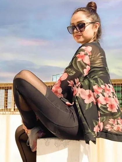 Athleisure can be glamorous too. Here, I've layered a sheer floral kimono over black leggings with mesh panels, creating a look that's both sporty and chic, perfect for a stylish evening.