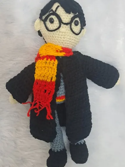 For all the magic lovers, here is my handmade Harry Potter doll. He comes complete with his glasses, Gryffindor scarf, and Hogwarts robe.
