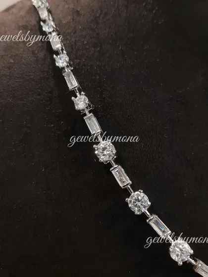 The clean, modern elegance of a diamond tennis necklace. This piece features a seamless line of round and baguette-cut diamonds, offering a sophisticated sparkle that is perfect for any occasion.