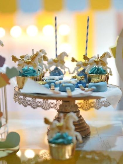 A close-up of the beautiful carousel-themed desserts, displayed on an elegant gold stand.