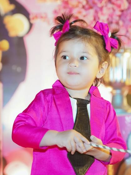 A perfect portrait of the birthday girl. Dressed in a stylish pink and black outfit for her Boss Baby themed party, her personality shines through in this candid shot.