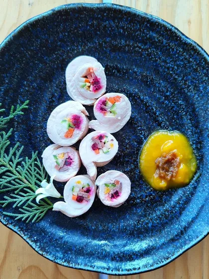 My kitchen is always busy creating unique pet snacks. These are my stuffed chicken rolls, filled with finely chopped vegetables and served with a side of pumpkin bacon jam. It's a perfect gourmet treat for your dog.