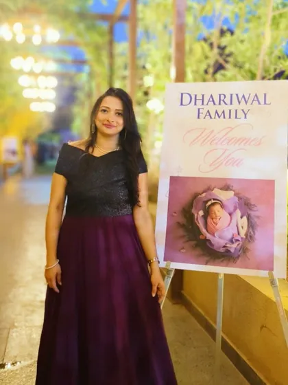 Standing by the welcome sign at a baby naming ceremony in Pune. The elegant decor and personalized touches create a warm and inviting atmosphere for celebrating a new arrival.