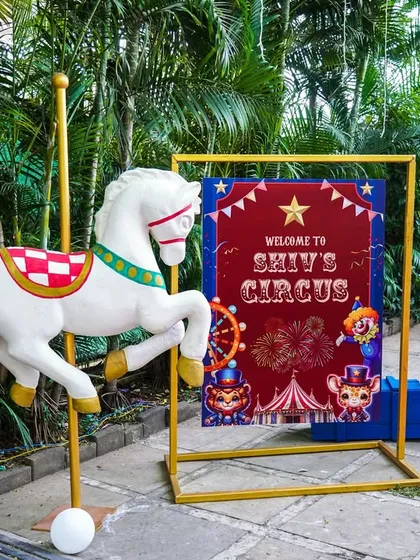 A classic carousel horse and welcome sign at the entrance to "Shiv's Circus."