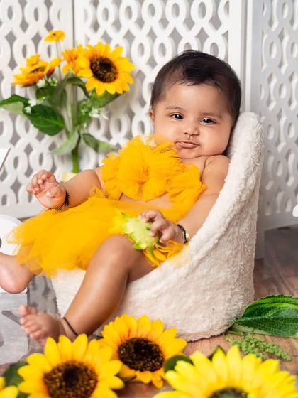 This little sunflower baby is celebrating six months with a pouty face that is too cute to handle. We capture all the moods and expressions.