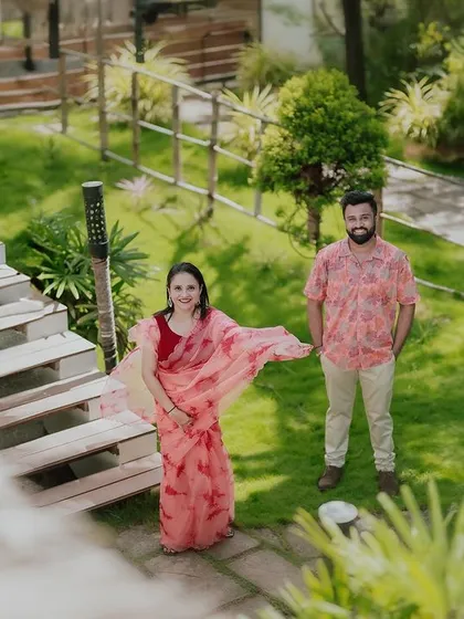 A high-angle shot looking down on the couple in the resort's garden, offering a unique and interesting perspective.