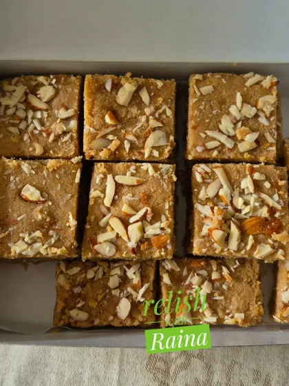 A box of Gur Papdi with a generous topping of sliced almonds, ready for a client.