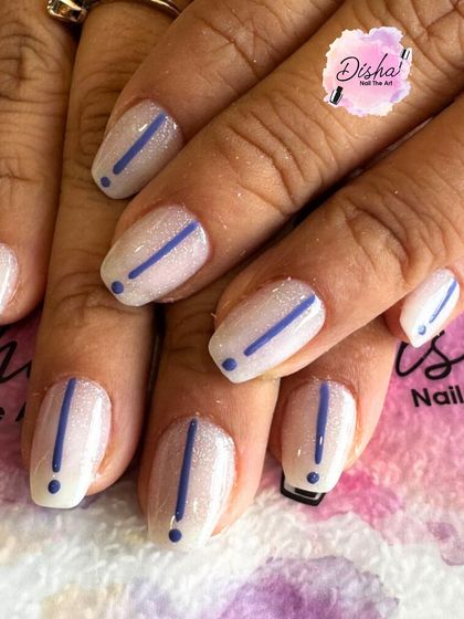A minimalist design with a pop of color. I created this clean look with a shimmery white base and a simple, crisp blue exclamation mark on each nail.