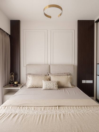 This guest bedroom at DNR Arista is all about understated elegance. Neutral tones, clean wall paneling, and warm accents create a calm, inviting space for any guest to feel instantly at home.