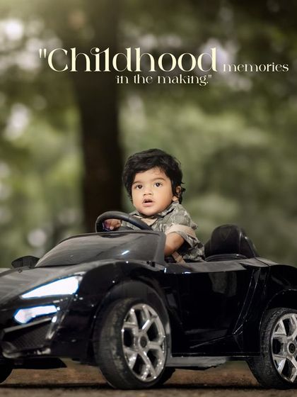 Childhood memories in the making. A toddler looks out from his toy car, ready for the next adventure.