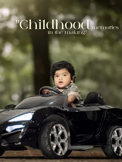 Childhood memories in the making. A toddler looks out from his toy car, ready for the next adventure.