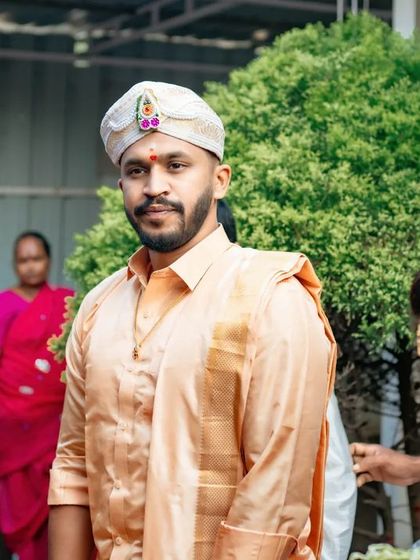 A candid shot of the groom during the wedding proceedings, looking calm and happy. We capture the groom's story as well as the bride's.