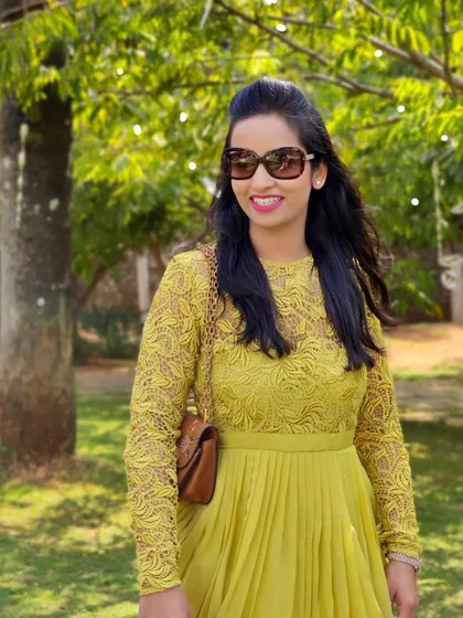 A close-up of Devika in her vibrant yellow lace dress, a perfect outfit for a sunny day out.