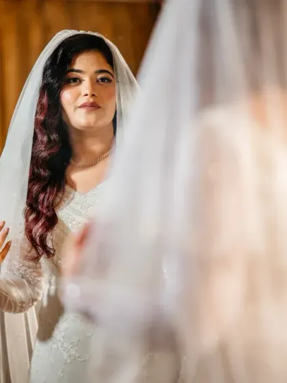 "Mirror, mirror on the wall." A classic bridal portrait, capturing the bride's reflection as she gets ready.