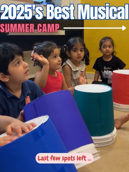 It's never too early to start a musical journey. This image from our musical summer camp shows toddlers engaged in a rhythm activity with colorful bucket drums, showcasing our focus on making music accessible and fun for children as young as three.