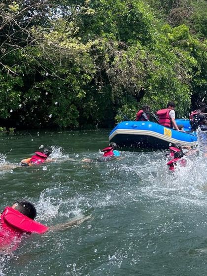 Campers take a break from paddling to swim and splash around the rafts, a fun part of every river journey.