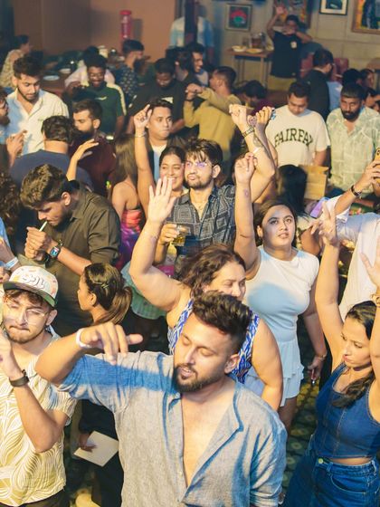 The entire club with their hands in the air.