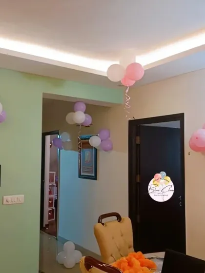Simple balloon bunches in pink and purple placed around a room to add a festive touch.