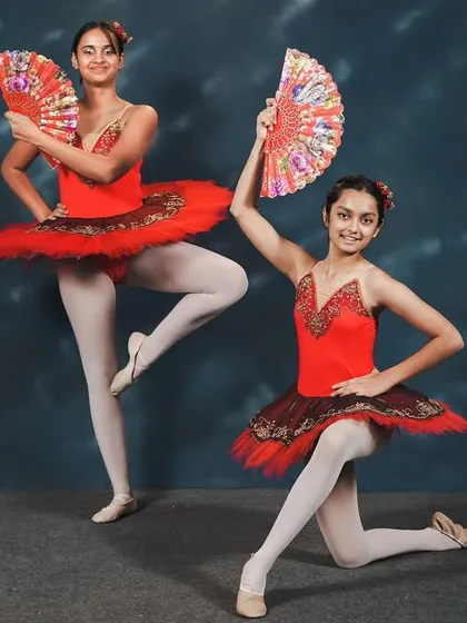 Dancers from our 'Don Quixote' performance. The use of fans as props adds a fiery, Spanish-inspired flair to the classic ballet choreography, showcasing both technique and personality.