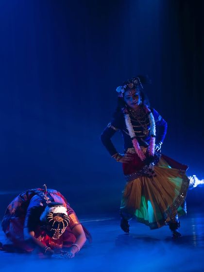 A moment of reverence and storytelling from "KRISHNA". The use of stage fog and focused lighting creates a divine atmosphere, transporting the audience to another realm.