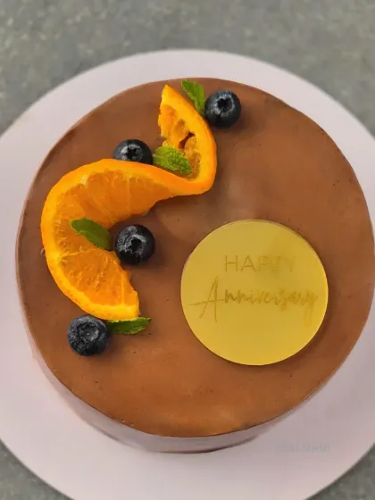 My signature Mocha Orange cake, simply decorated with a fresh orange slice and blueberries. The flavour is a perfect marriage of rich coffee and zesty orange.