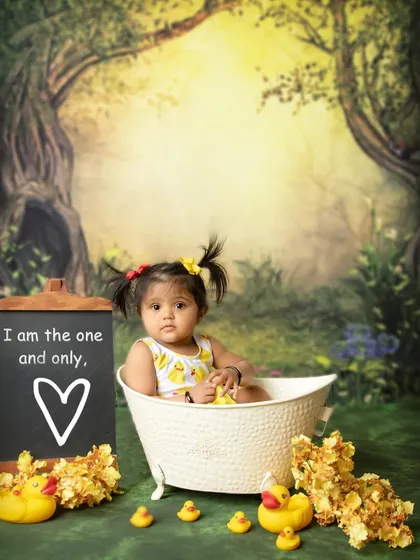 A sweet and simple portrait from the duck-themed bath session. The chalkboard sign adds a personal touch to celebrate her being "the one and only."