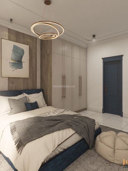 The bedroom features a modern chandelier and a blue door with classic moulding, blending old-world charm with contemporary style.