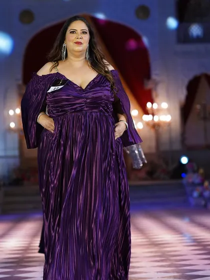 Another look at the pleated purple plus-size gown. The color is so regal and the design is incredibly elegant.