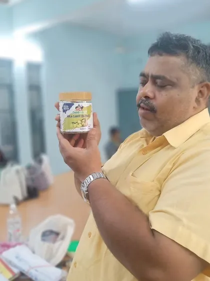 A customer carefully inspecting the label of our Amla Candy jar. We are proud of our simple, natural ingredients and transparent packaging.