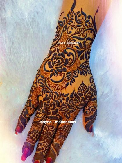 A heavy designer piece with a focus on intricate floral and paisley work.