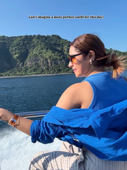 Can't imagine a more perfect outfit for a day of island hopping. The comfortable layers and practical tied-up hair are perfect for the wind and sun.