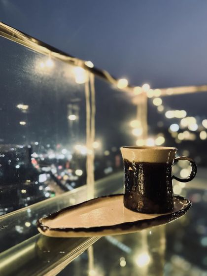 Another view of the mug and plate set from our Shibui Collection. The contrast between the raw ivory clay and the metallic glaze is stunning.