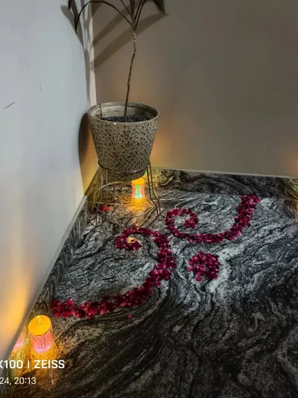 A simple rangoli made with rose petals and lit with small battery-operated candles, perfect for decorating corners.